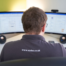 Person Working on Audio Visual Meeting Room Designs on Screen