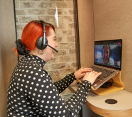 Person Using Personal Meeting Space Pod for a Video Conference Call