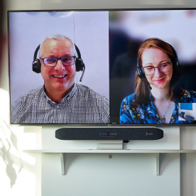 Close Up of Two People on a Video Conference Call in Boardroom