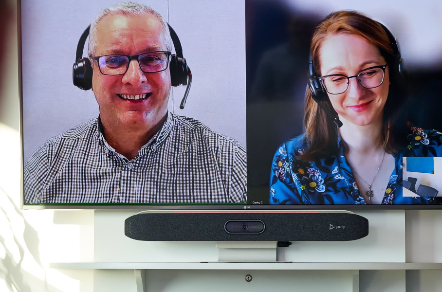 Close Up of Two People on a Video Conference Call in Boardroom