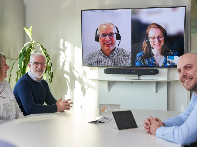 People Meeting in Boardroom Using Video Conferencing