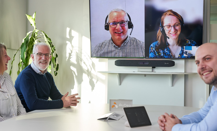 People Meeting in Boardroom Using Video Conferencing