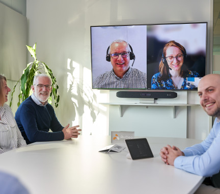 People Meeting in Boardroom Using Video Conferencing