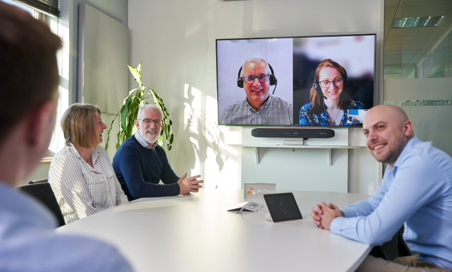People Meeting in Boardroom Using Video Conferencing