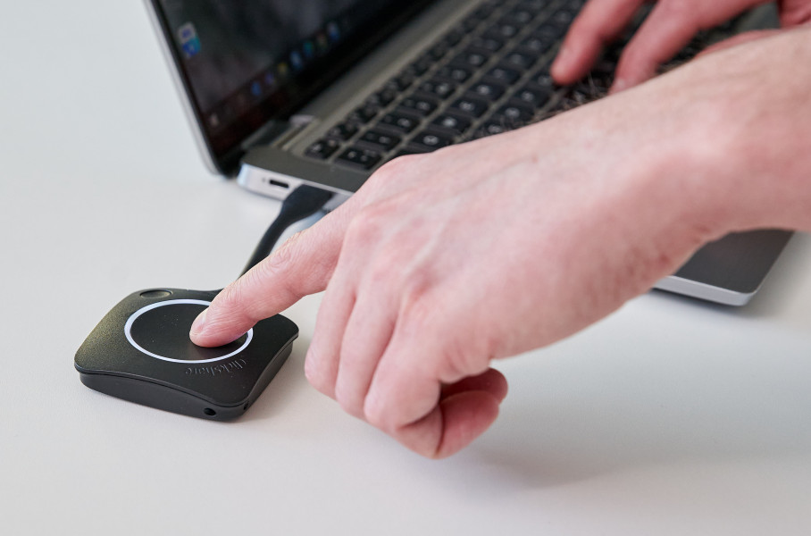 Person Using Barco Wireless Presentation Button with Laptop