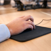 Person Using a Mouse at Desk