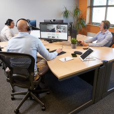 People Using Hot Desks in Office